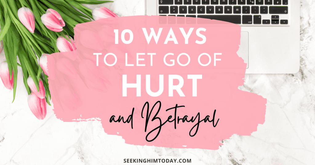 Image of pink tulips and a keyboard on a marble countertop with text overlay saying: 10 ways to let go of hurt and betrayal